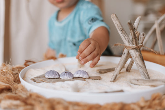Beachcombing for potion play and sensory tray. Driftwood teepee deserted island play tray ideas 