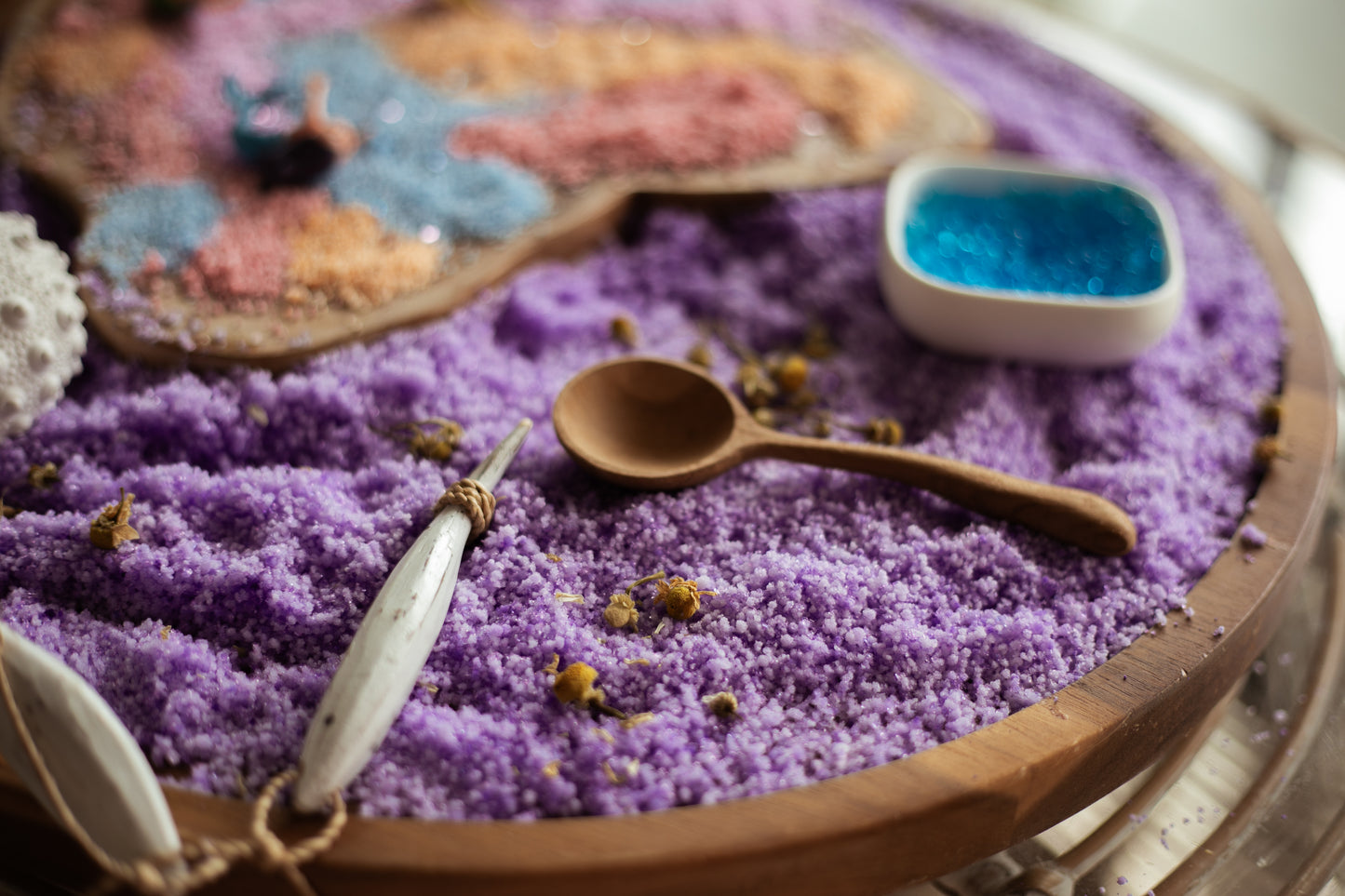 snowflakes white instant snow. turned purple using purple food dye in the water before activating. creating a mermaid sensory play tray