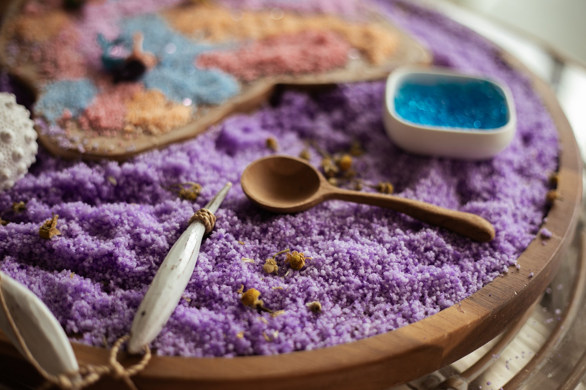 snowflakes white instant snow. turned purple using purple food dye in the water before activating. creating a mermaid sensory play tray